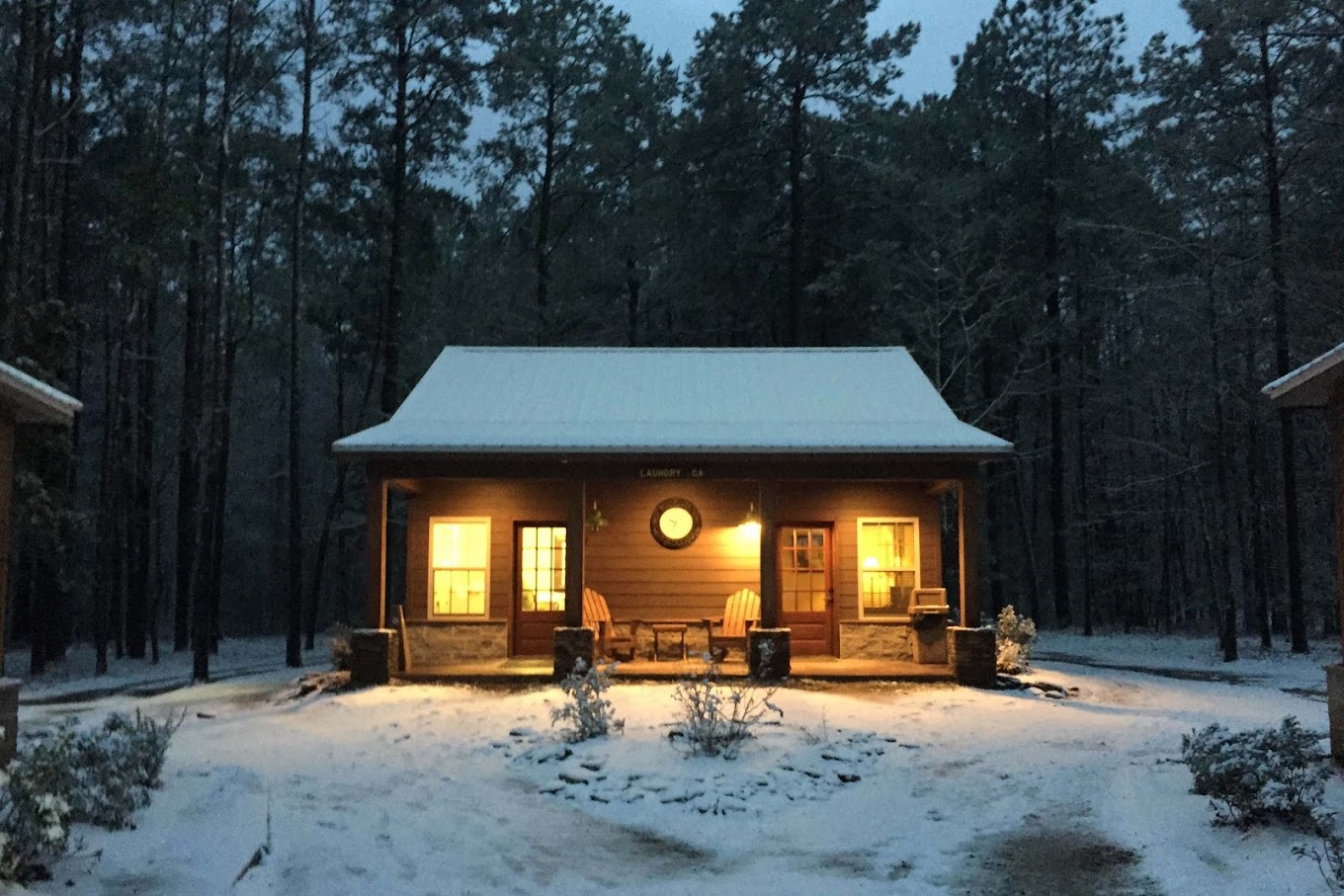 Snow-covered cabin with warm glowing lights