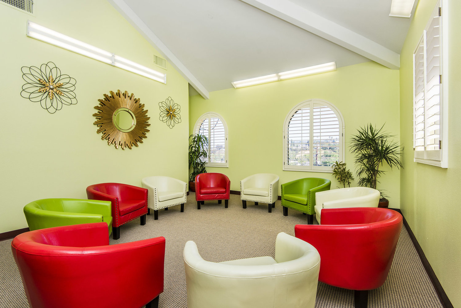 Bright therapy room with colorful chairs in a circle