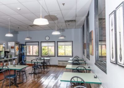 Bright dining room with round tables and large windows