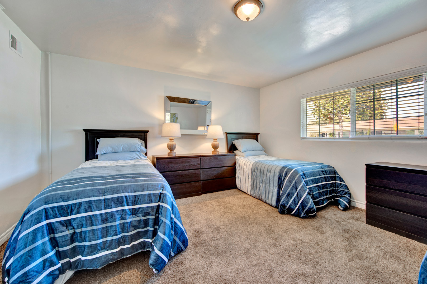 Shared rehab bedroom with twin beds and dresser.