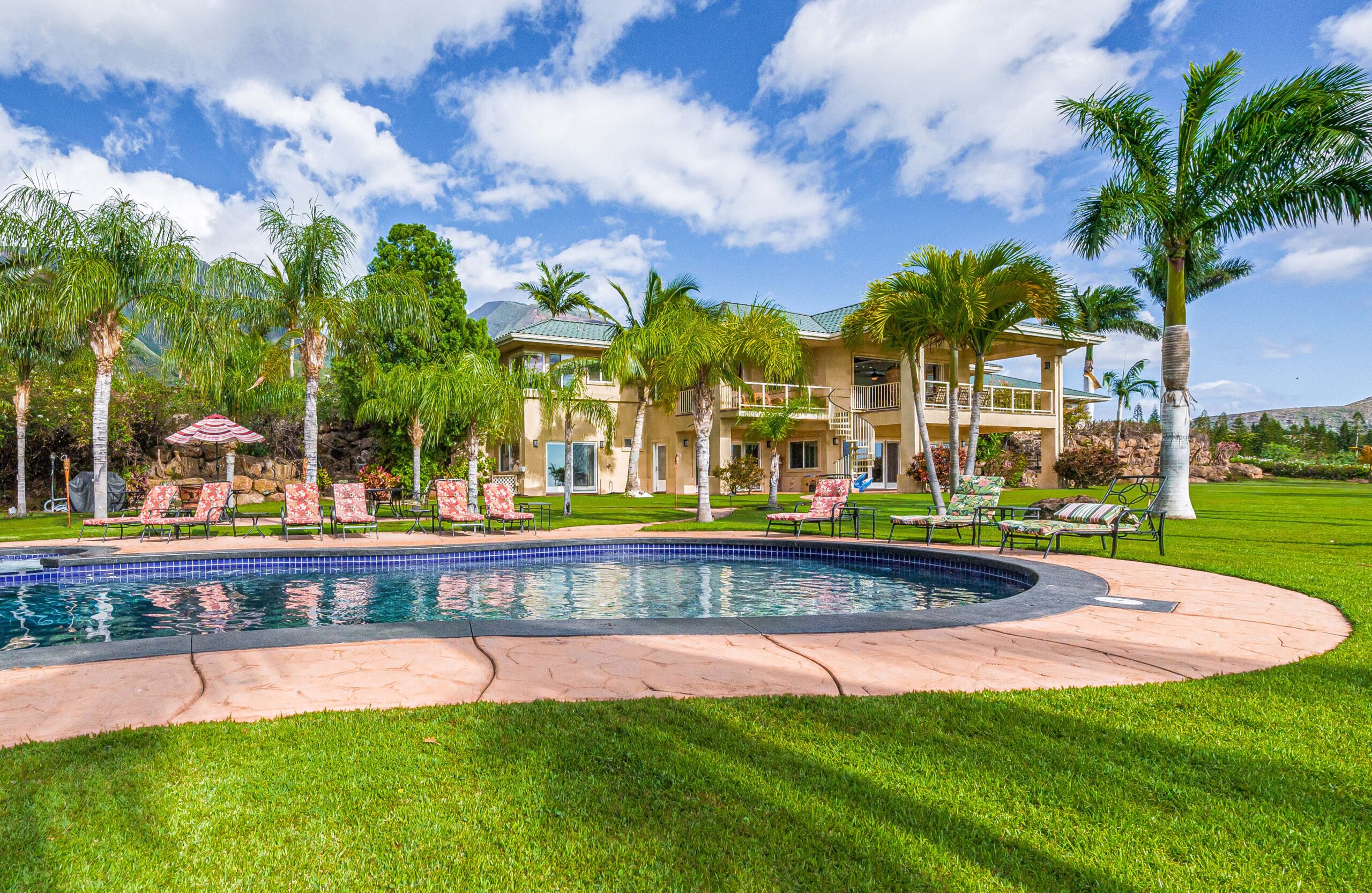 Resort-style swimming pool with lounge chairs overlooking the Maui Recovery estate