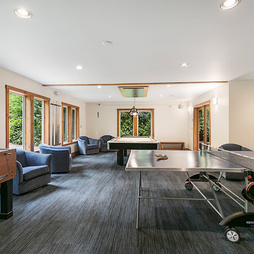 Game room with a pool table, table tennis, and seating.