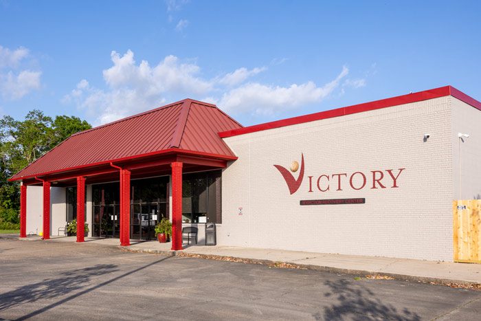Rehab center exterior with red roof and Victory logo