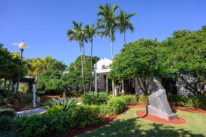 Garden entrance surrounded by palm trees and plants
