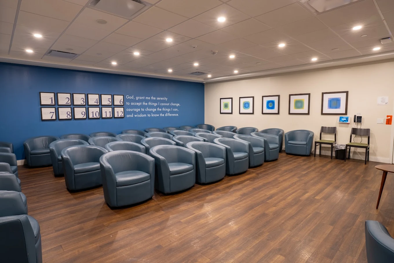 Meeting room with rows of blue upholstered chairs