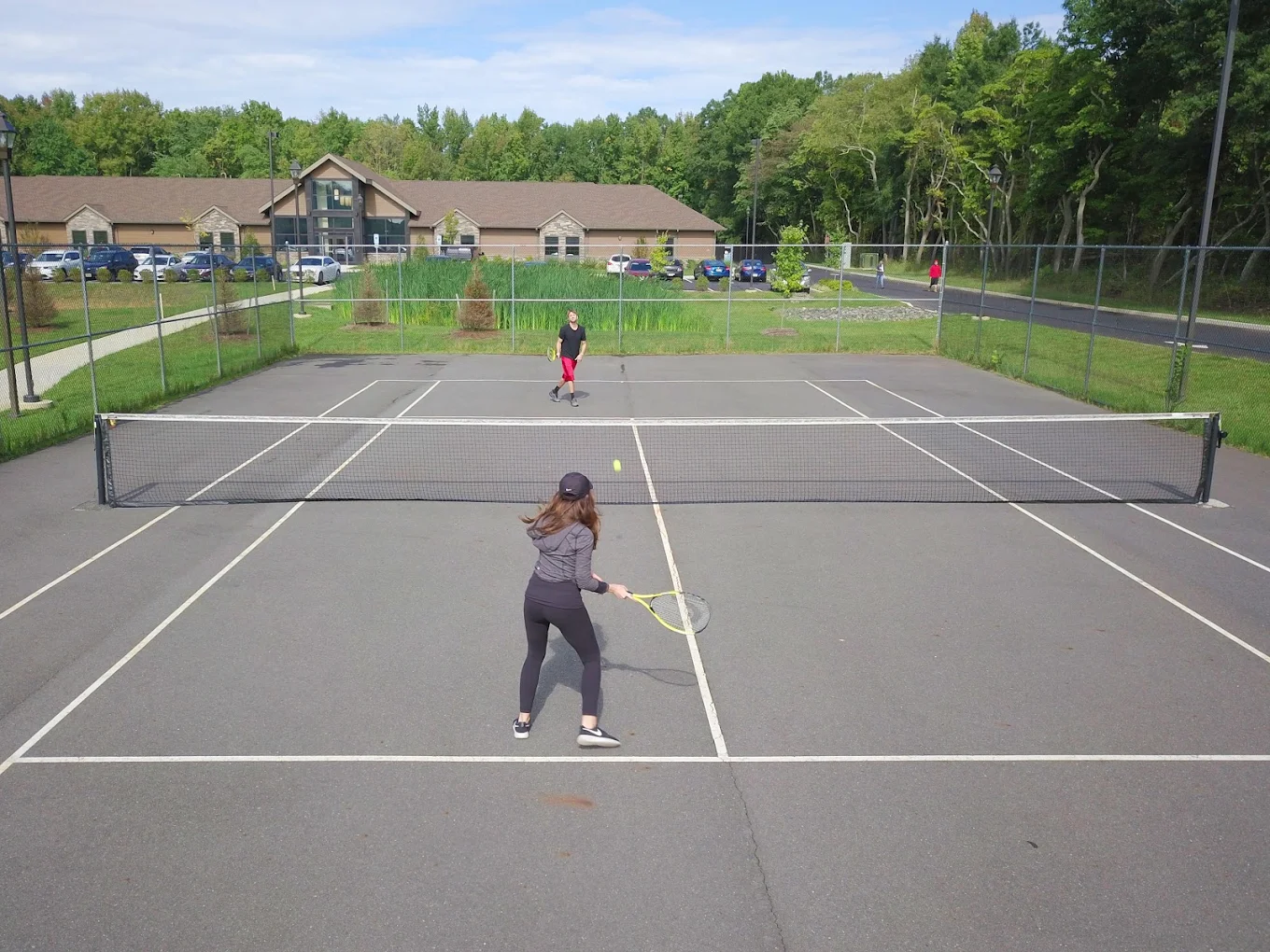 Fenced tennis court near facility