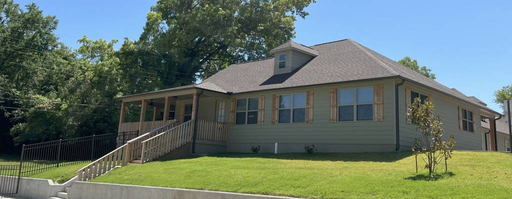 Street view of a one-story rehab facility with front porch ramp