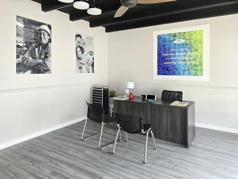 Private office with desk, chairs, and motivational wall art