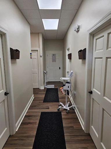 Clinic hallway with wood floors and white doors
