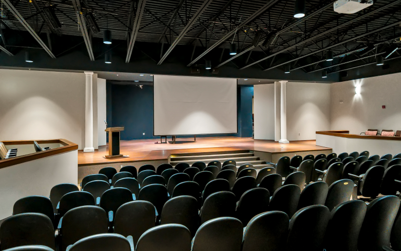 Auditorium with stage and large presentation screen