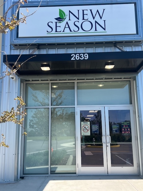 New Season entrance with glass doors and facility sign
