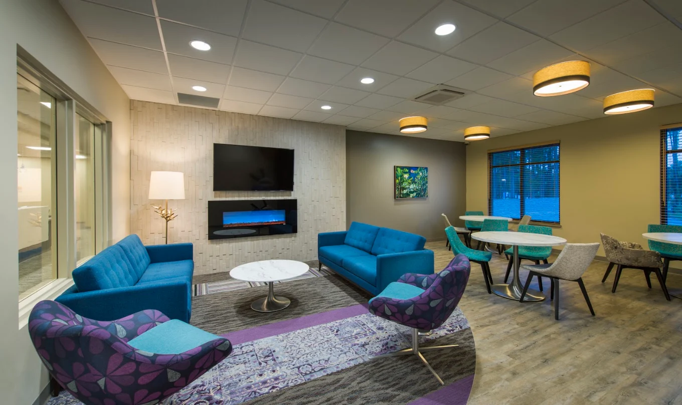 Common area with blue sofas, tables, and fireplace
