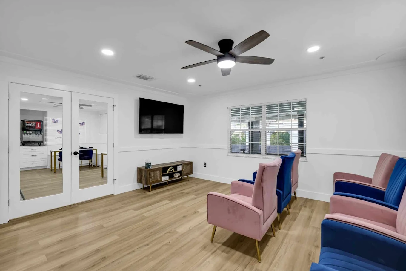 Community lounge with seating and wall-mounted TV