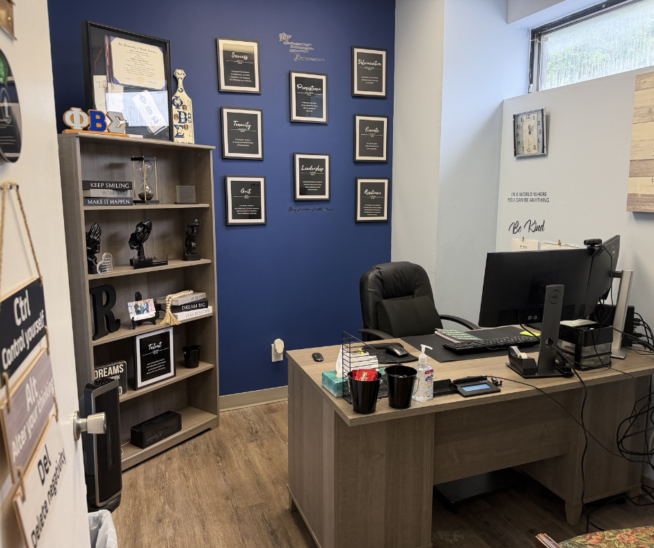 Counselor office with desk, shelving, and motivational decor