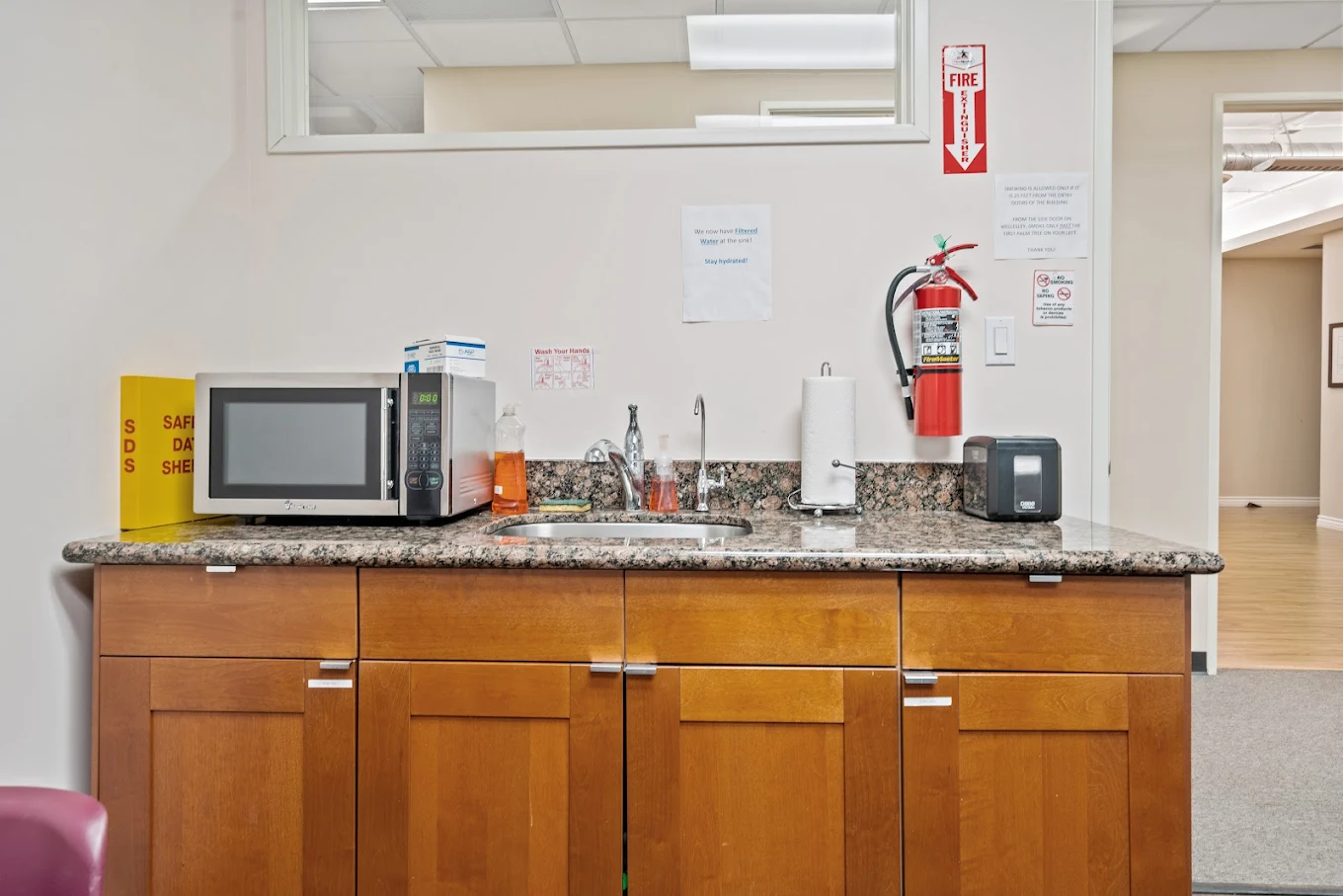 Kitchenette with microwave, sink, and cabinets