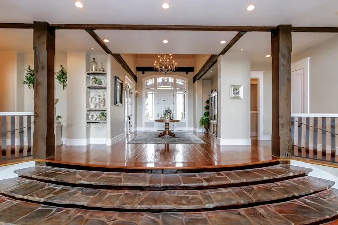 Bright hallway with round floral table and glass door