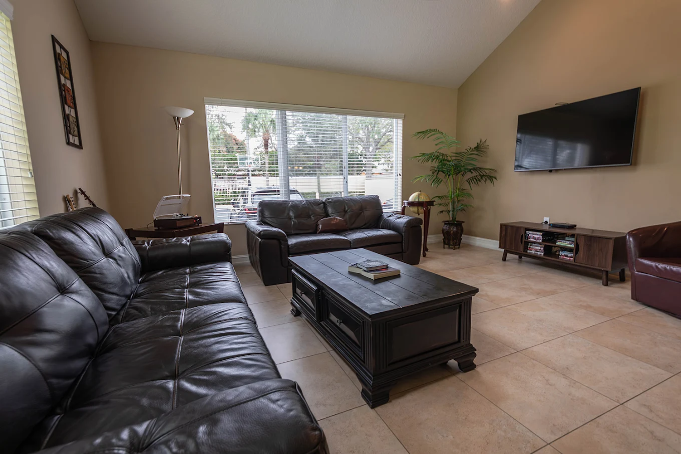 Spacious lounge with leather sofas and large window view