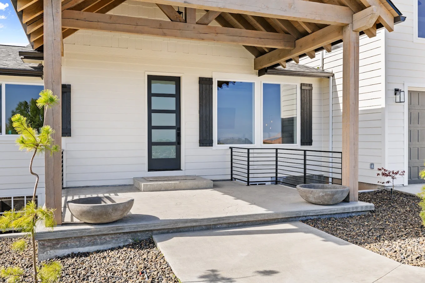 Covered front entrance with modern door and wooden beams