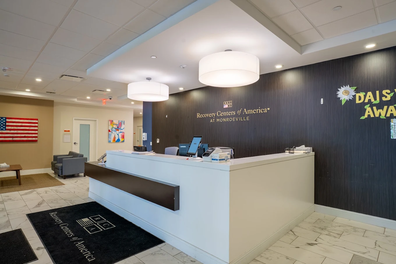 Reception desk with Recovery Centers of America wall signage