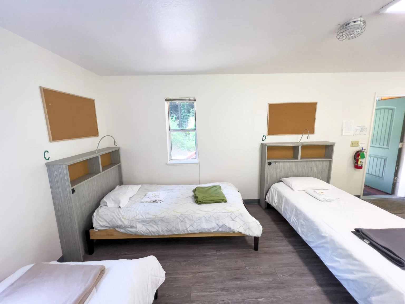 Simple bedroom with two beds and wall shelves