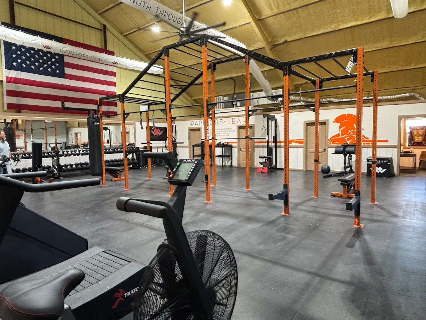 Indoor fitness gym with cardio machines and weight racks