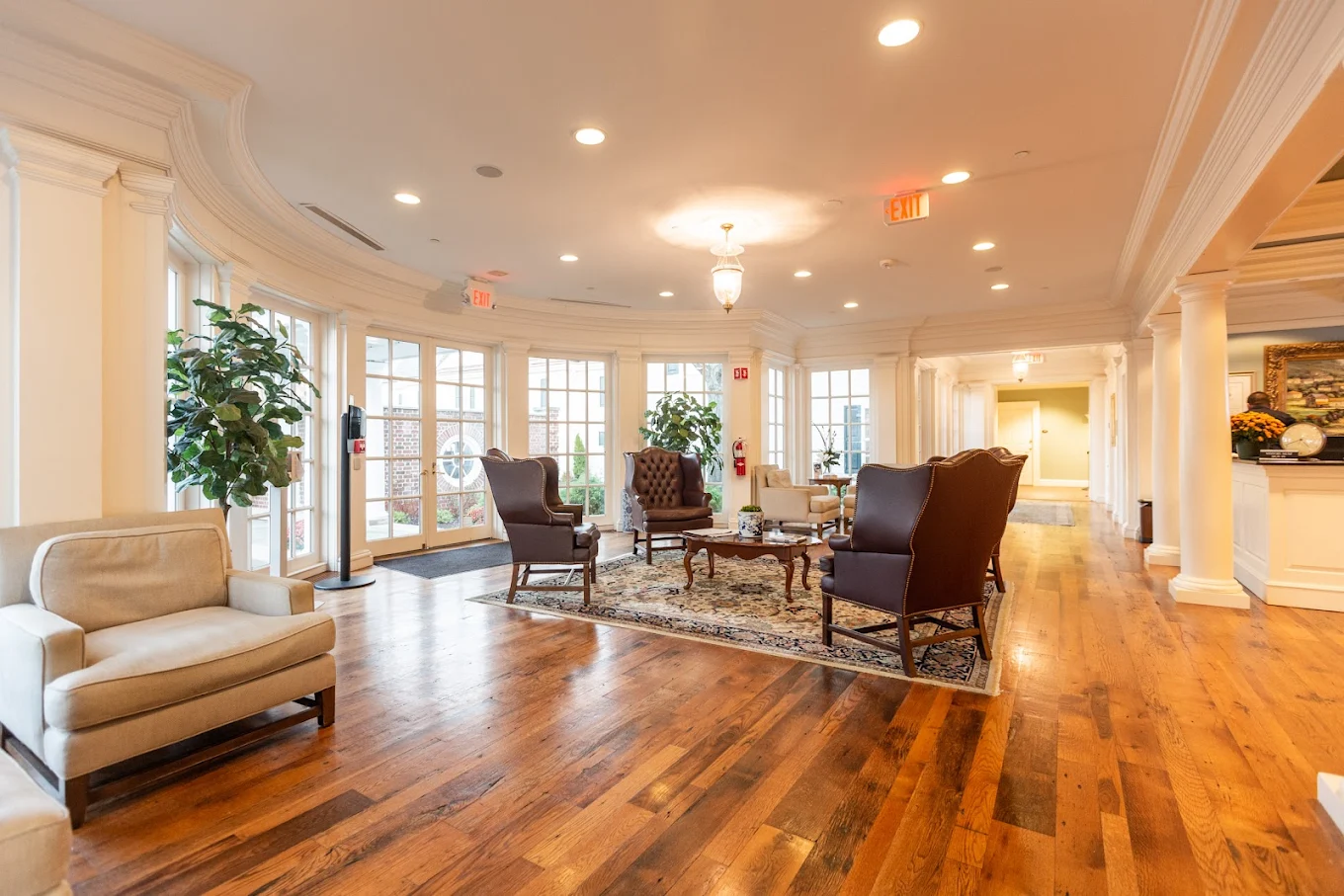 Spacious common area with seating and polished wood floors