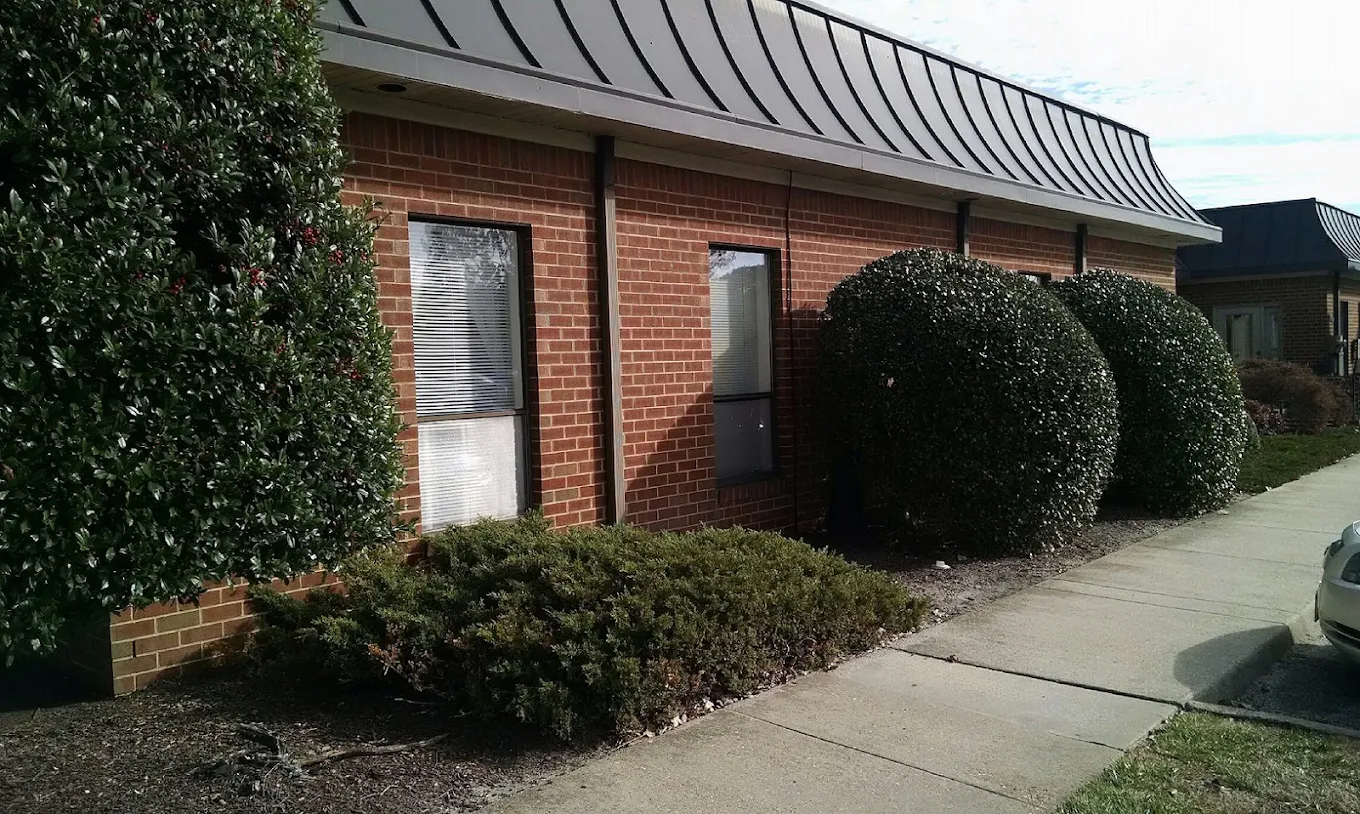 Side view of brick treatment center with landscaped walkway