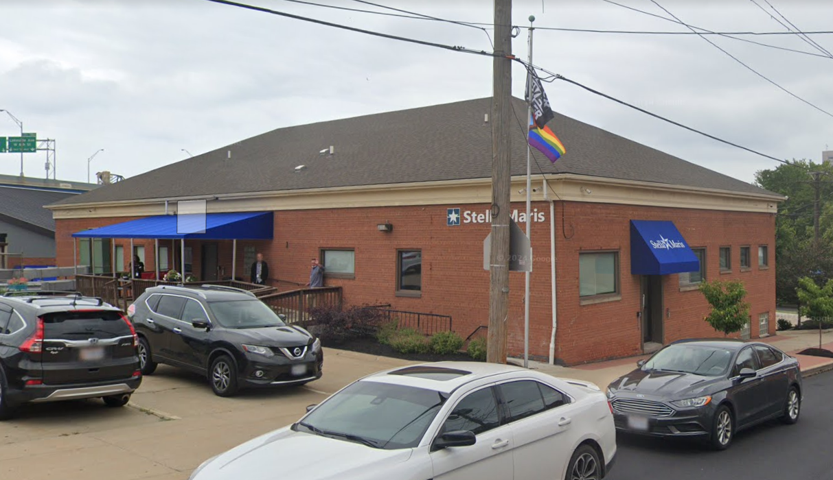 Side entrance with blue awning at Stella Maris Madden Center