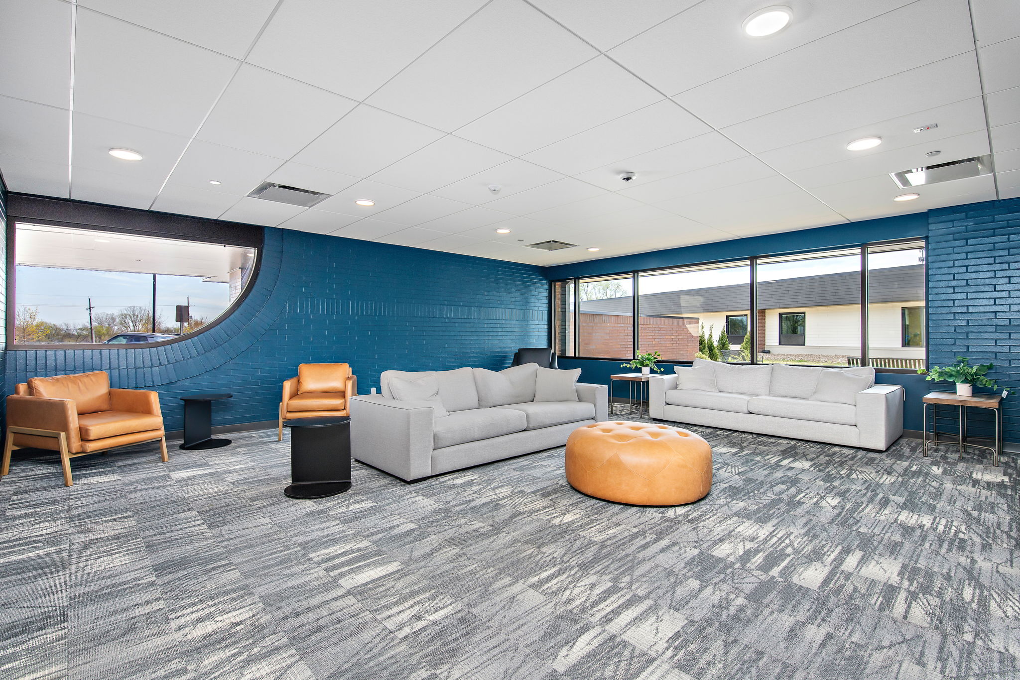 Spacious lounge with large windows and modern seating