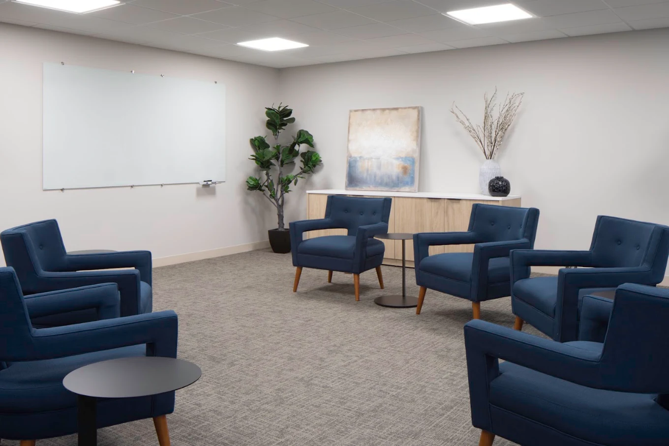 Group room with blue armchairs arranged for meetings