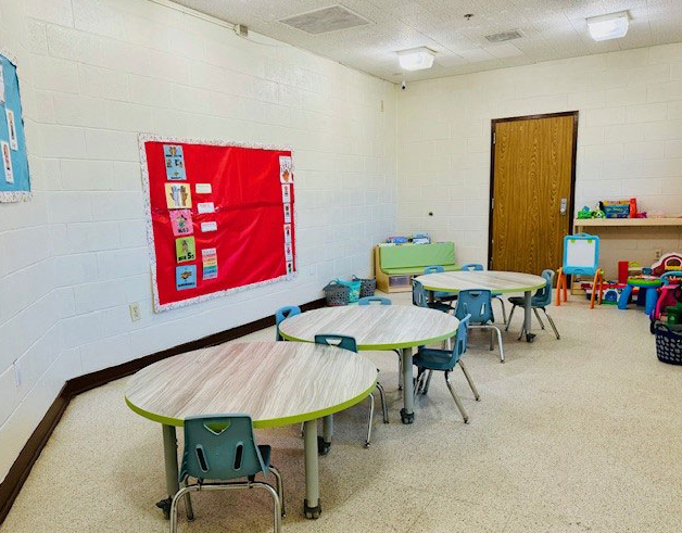 Bright classroom with small tables and chairs