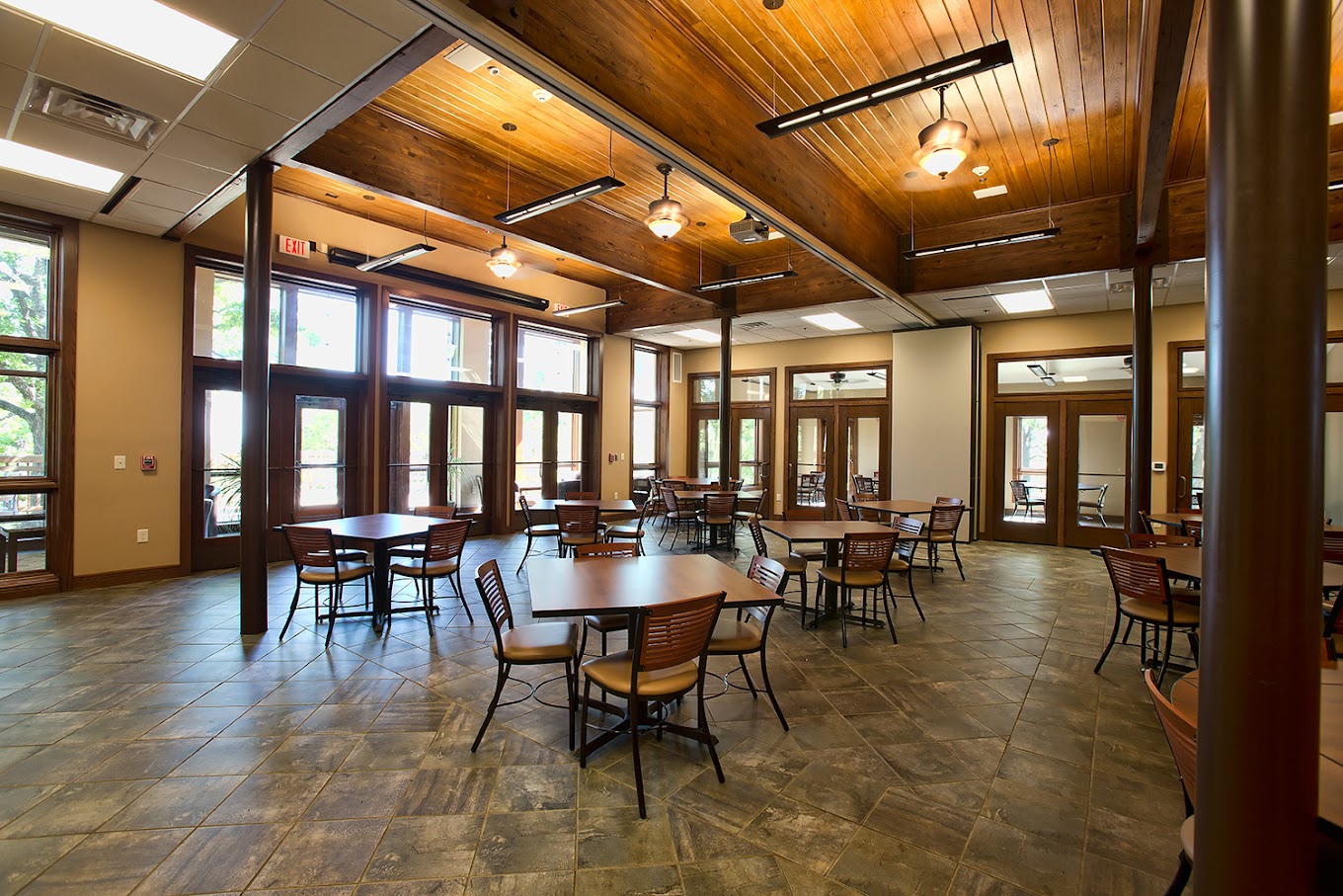 Spacious dining hall with wooden ceilings and large windows