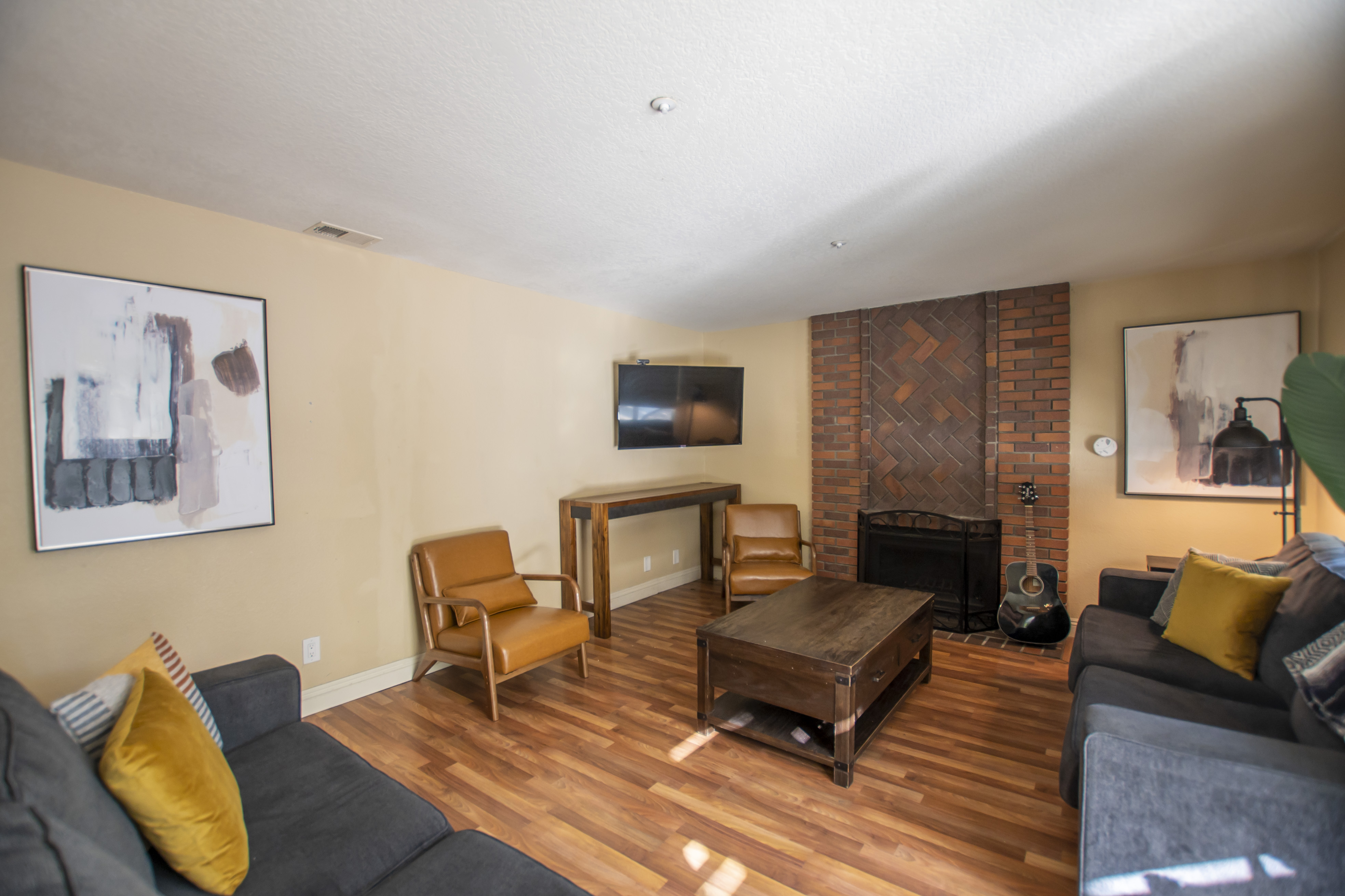 Brick fireplace with seating and mounted TV