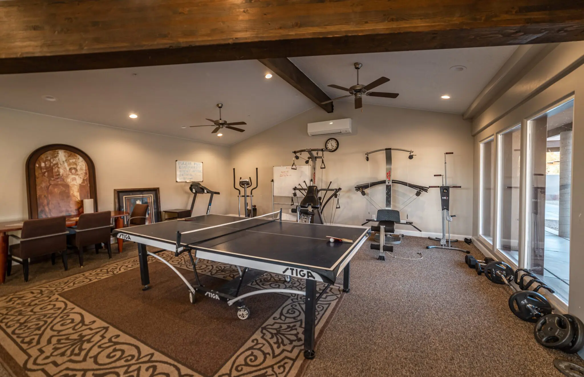 Indoor fitness room with equipment and table tennis
