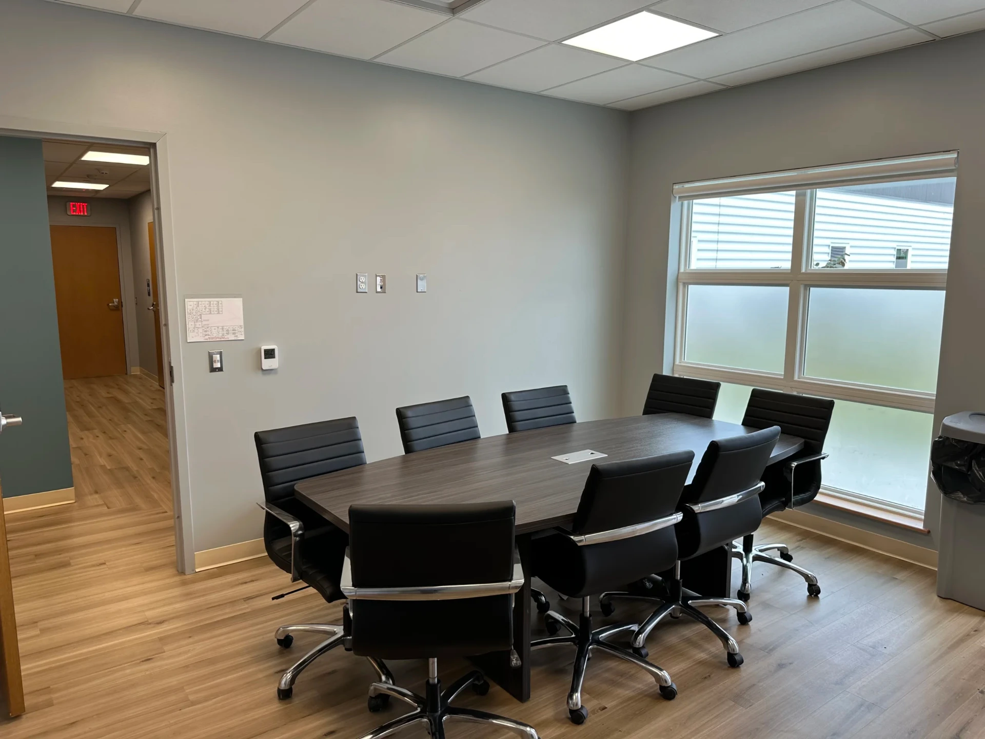 Meeting room with conference table and seating.