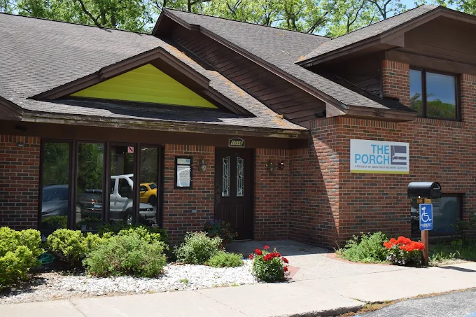 Brick rehab facility with front entrance and The Porch sign