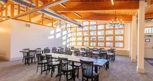 Dining room with wooden ceiling and tables
