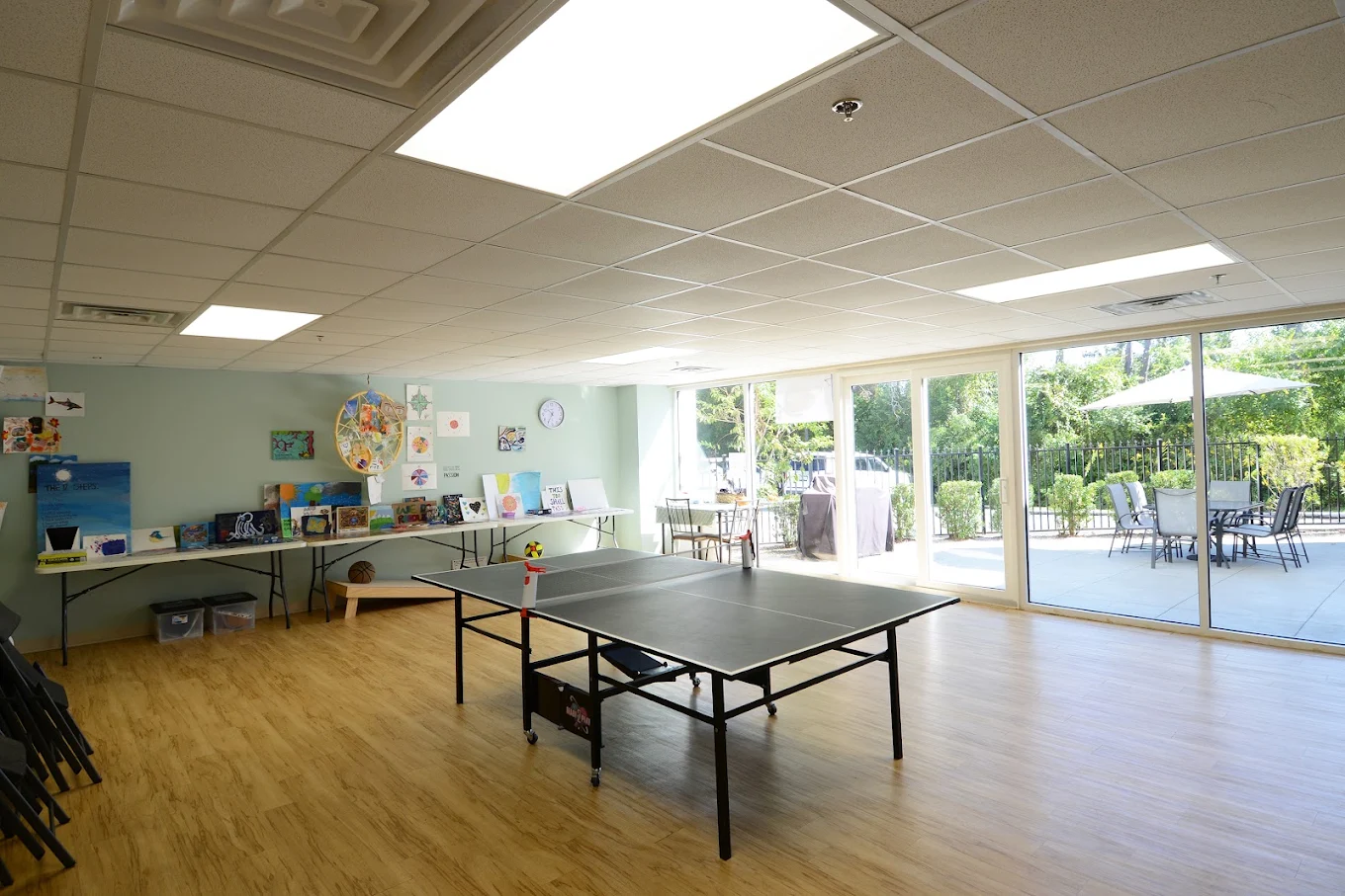 Activity room with ping pong table and recreation supplies