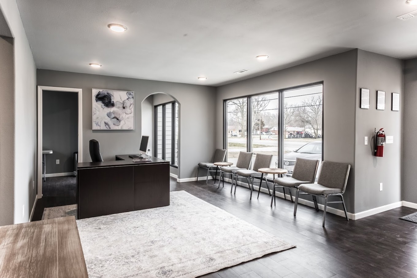 Bright reception area with windows, desk, and guest chairs