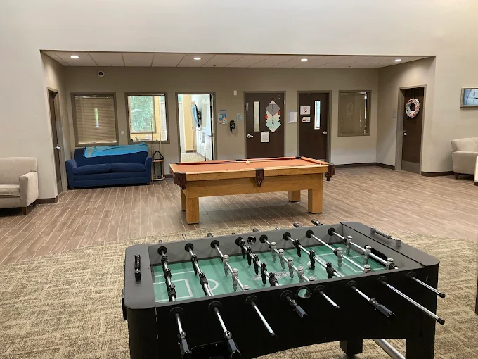 Game room with foosball, pool table, and lounge seating