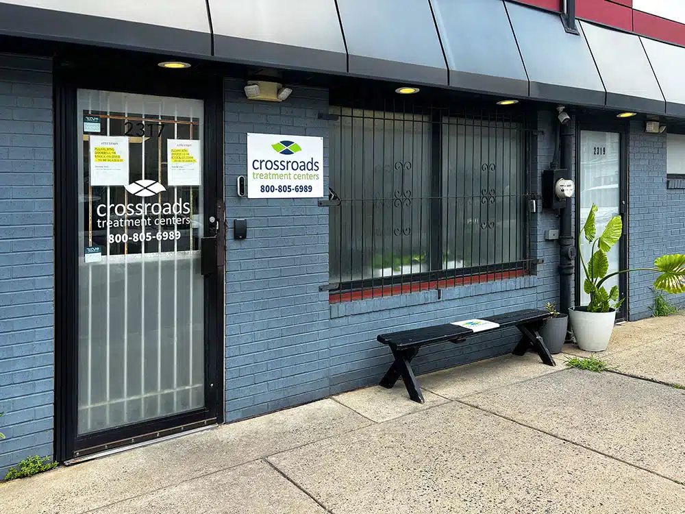 Exterior entrance with Crossroads sign and bench outside