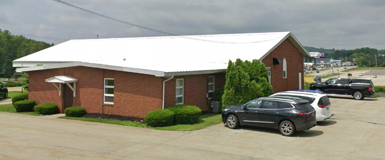 Side view of brick building with parking area