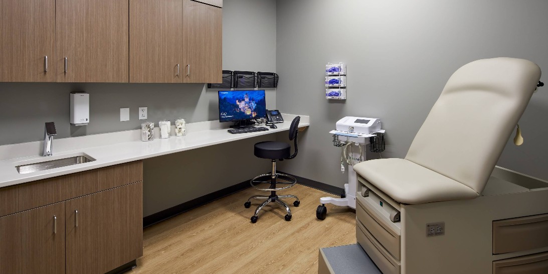 Medical exam room with examination table and clinical equipment