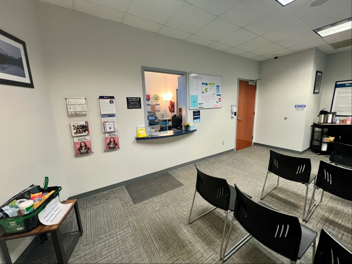 Waiting area with chairs and reception window
