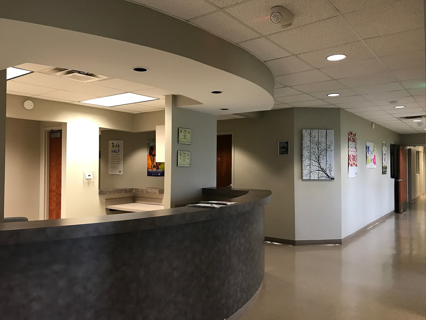 Reception area with a desk leading to a hallway.