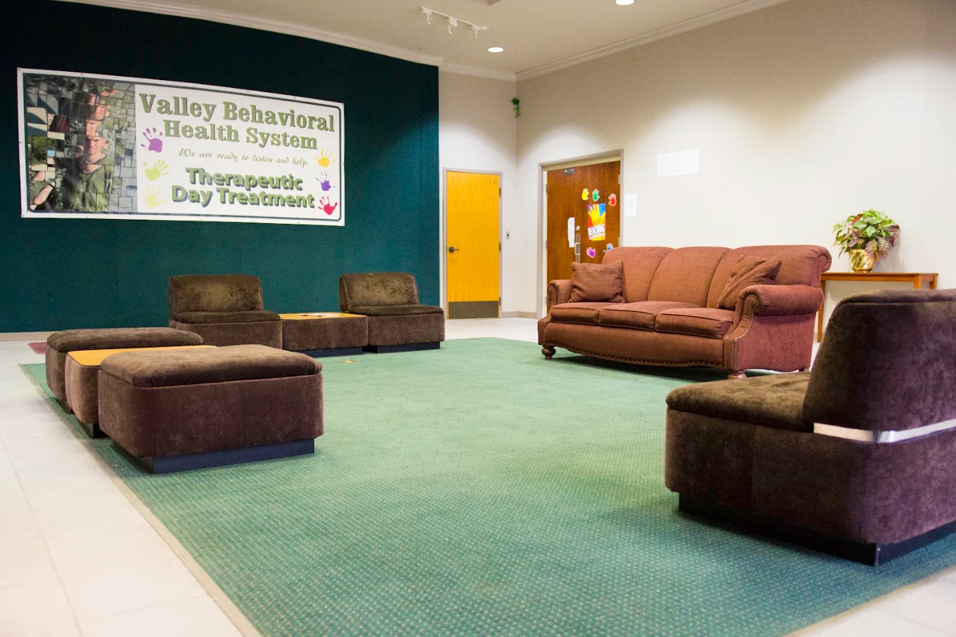 Waiting area with chairs and doors visible.
