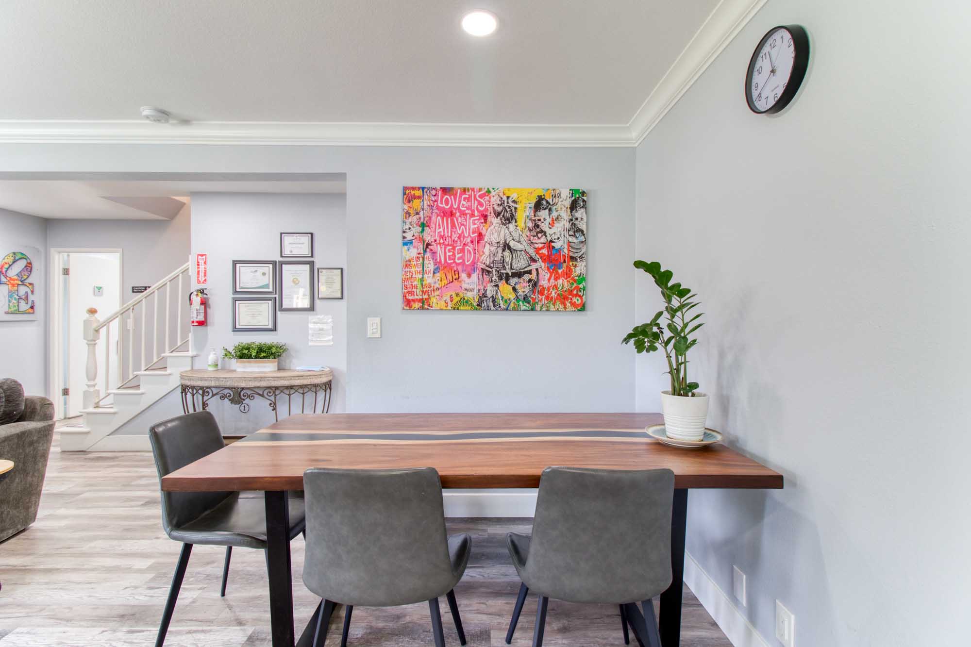 Dining table with art decor and greenery under soft lighting