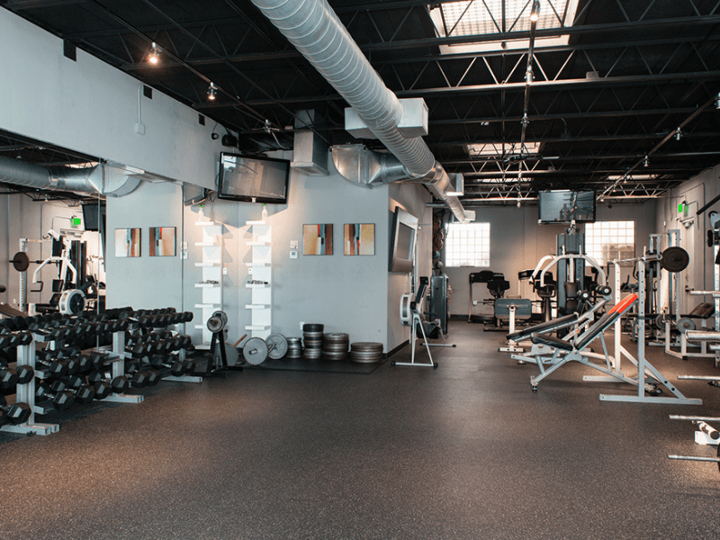 Spacious gym with weightlifting and cardio equipment