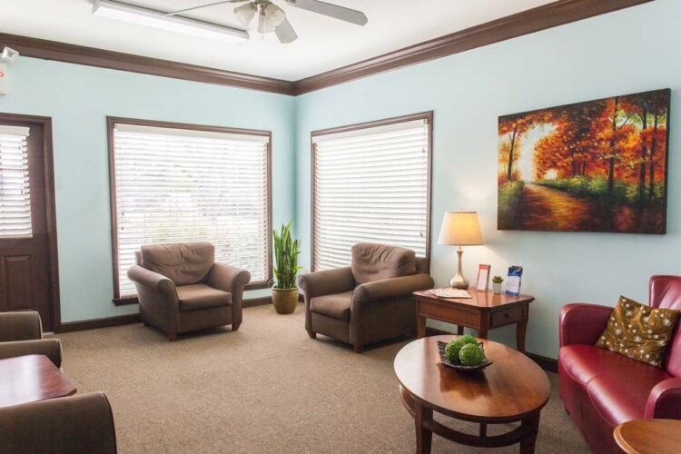 Bright lounge with armchairs and large windows