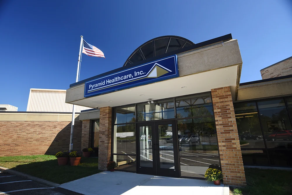 Main entrance with glass doors and blue signage above